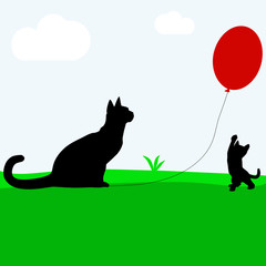 Сats playing with a red balloon