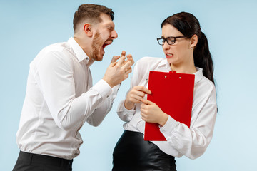 Angry boss. Man and his secretary standing at office or studio. Business man screaming to his...