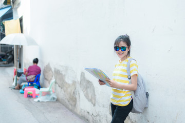 A woman is looking at a map for traveling,traveling in Thailand,traveling in Chiang mai