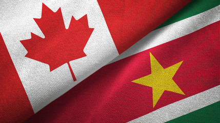 Fototapeta premium Canada and Suriname two flags textile cloth, fabric texture