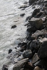 strong sea waves and foam with stones in the sea