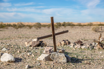A cross on an unmarked grave, in a small roadside cemetery near The Imperial Sand Dunes, California