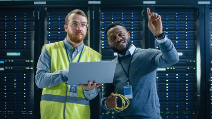 IT Specialist in Glasses and High Visibility Vest with Laptop Computer and Black Technician...