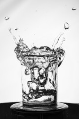 Splashing water in the glass, black and white