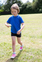 school girl doing the egg and spoon race on sports day