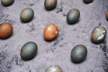 Chicken painted eggs in box on stone background.
