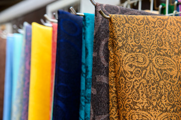 Rows of fabrics hanging at a market stall 