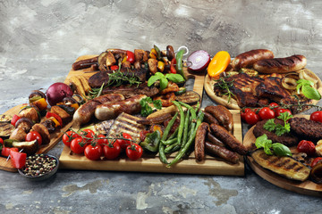 Assorted delicious grilled meat with vegetable on rustic table