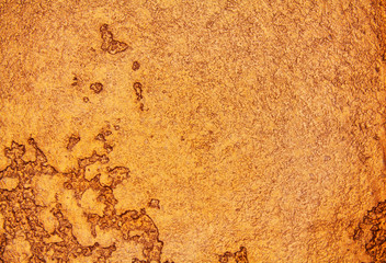 abstract golden grunge background. The texture of the wall of decorative plaster.