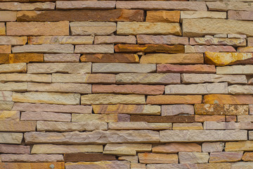 Beautiful pattern of old decorative stone wall background. Vintage stone wall Texture in weathered and have natural surfaces for design background. Featured pattern gray color of antique stone wall.