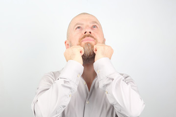 Bearded man with raised hands looking up
