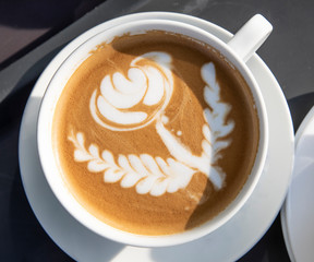coffee with a flower formed with milk foam