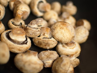 Mushrooms in hoarfrost. Frozen mushrooms in a skillet. Mushrooms in hoarfrost on a black skillet.