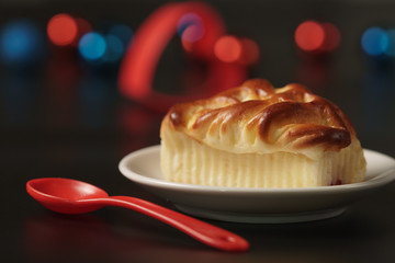 Tasty homemade pie with forest fruits on black background.