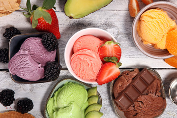 Set of ice cream scoops of different colors and flavours with berries, chocolate and fruits.