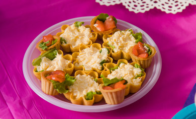 First baby girl birthday party concept. Table for kids and decor items in bright pink colors.