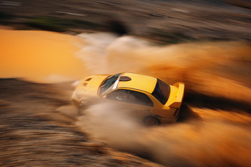 Rally vehicle going fast with mud and water splash