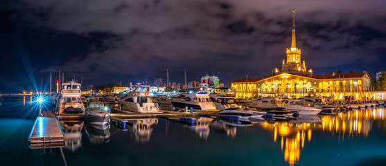 Marine Station of Sochi, illuminated with lights at night with reflection in water
