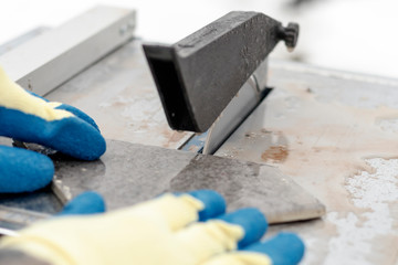 water is supplied to the electric machine. Master cuts the tile. close-up