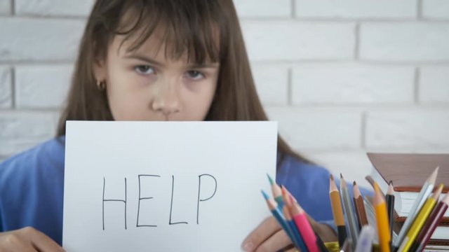 Schoolgirl in depression. Sad little girl asks for help with learning.