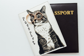 newlyweds wedding rings on a funny passport cover with a cat