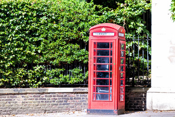 London, UK Street road in Chelsea Kensington district neighborhood area by vintage retro red telephone booth and nobody on pavement