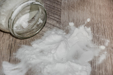 white soda on a wooden table and a glass jar