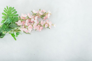 Obraz na płótnie Canvas Pink flower bouquet In the corner of the white scene