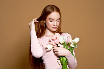 Woman with tulips bouquet and gift box. Birthday. March 8. Mother day.