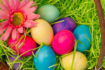 Fototapeta na wymiar Overhead closeup of colored Easter Eggs in Basket
