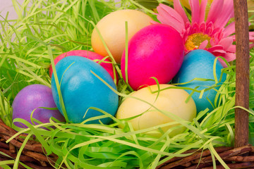 Fototapeta na wymiar Closeup of Colored Eggs in Easter Basket