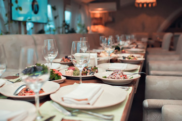 The table served for a banquet with snack and glasses