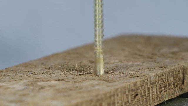Usando uma furadeira de coluna para fazer um furo com uma Broca de madeira