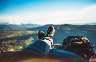 view trekking feet tourist backpack photo camera in auto on background panoramic landscape mountain, vacation concept, foot photograph hiking relax in auto, photographer enjoy trip holiday, mockup sky - obrazy, fototapety, plakaty