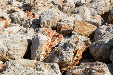 Background of large beige red stones. Geological abstract texture. Large boulders of sandstone