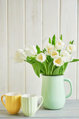 Naked cake with lemons and limes. Lemonade and flowers tulips on table. Mason jar glass of lemonade with lemons and straw. Copy space. Concept of spring and summer season. Healthy Food and Drink