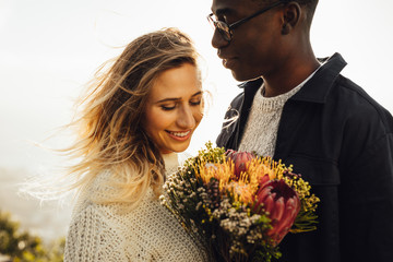 Beautiful couple outdoors with flowers