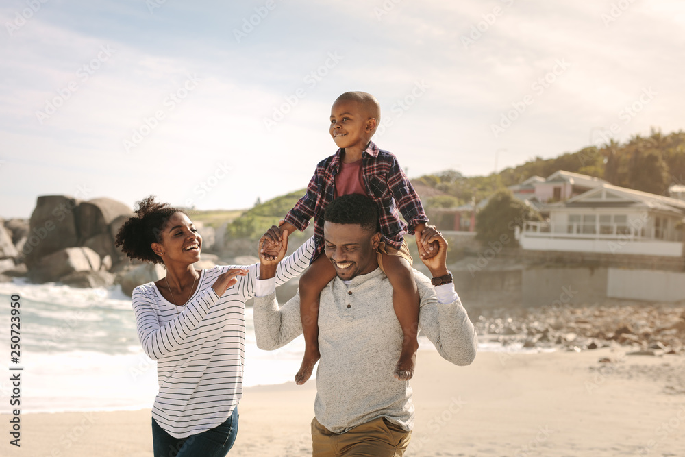 Wall mural Family having fun on beach vacation