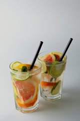 Traditional summer drink lemonade. With strawberries, oranges, lemon, lime, and grapefruit. Vertical iamge, toned.