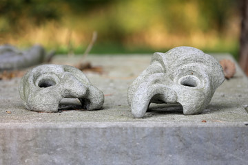 masks on gravestone at municipal cemetery in Amsterdam, The Netherlands