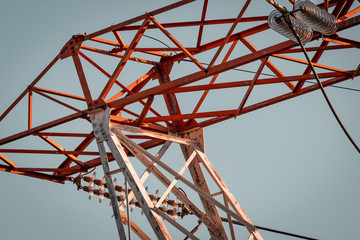 Power pylon array and details. Energy plant, red and white metal. Elctricity distribution grid, clean energy and local politics. National consumer supply for housing and cities. 