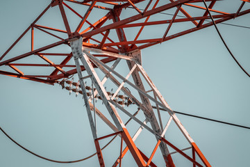 Power pylon array and details. Energy plant, red and white metal. Elctricity distribution grid, clean energy and local politics. National consumer supply for housing and cities. 