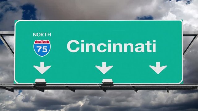 Cincinnati Ohio interstate route 75 overhead freeway directional arrow sign with time lapse clouds.