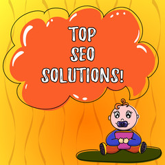 Text sign showing Top Seo Solutions. Conceptual photo methodology of techniques to increase amount of visitors Baby Sitting on Rug with Pacifier Book and Blank Color Cloud Speech Bubble