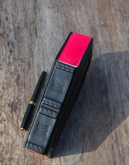 Leather book in shape of coffin, with a pencil on it