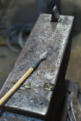 The blacksmith forges an arrowhead hammer on the anvil