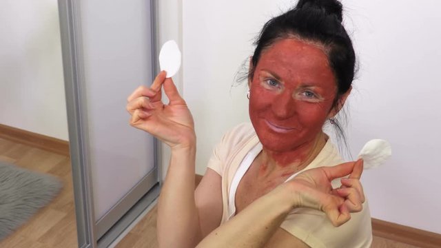 Happy Woman with cosmetic clay mask