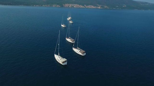 Aerial. Seven yachts lined up on Adriatic sea in Montenegro
