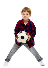 Little boy is playing with a soccer ball.