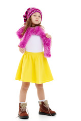 Little girl in a hat and scarf.